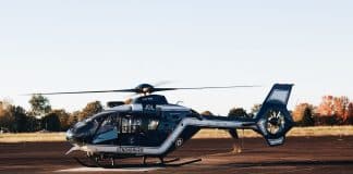 a helicopter sitting on top of an airport tarmac