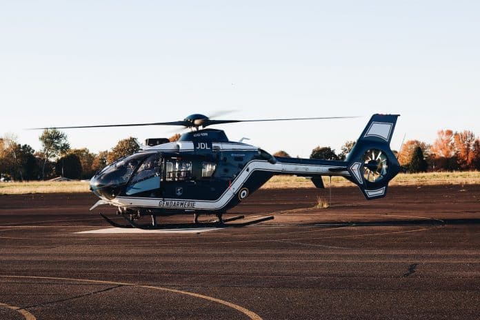 a helicopter sitting on top of an airport tarmac